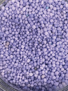 Purple TSN stabilized urea granules, photographed for the Taurus 2027 Product Guide.